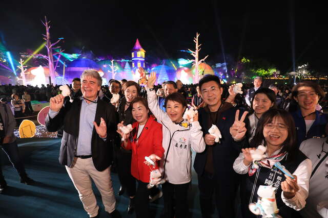 众人手拿姆明吊饰合影-现场气氛热络